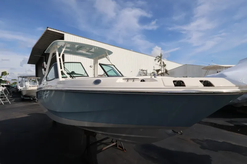 Slide: The Image of Boston Whaler 240 Vantage 2027 in a marina area, featuring a blue hull and white canopy. - 5