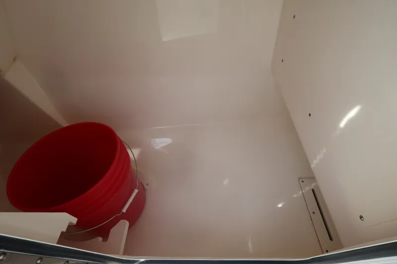 Slide: The Image of Interior space with a red bucket in a Boston Whaler 240 Vantage boat. - 31