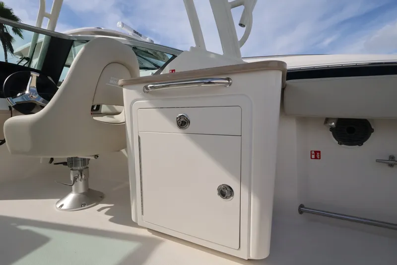 Slide: The Image of The 2027 Boston Whaler 240 Vantage features a sleek cockpit with a white cabinet. - 15