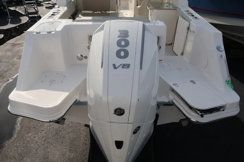 Slide: The Image of The image shows the stern of a Boston Whaler 240 Vantage with a 300 HP V8 engine. - 7