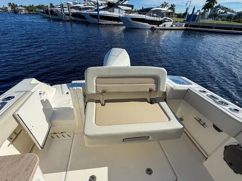 Slide: The Image of The image shows the cockpit of a 2027 Boston Whaler 240 Vantage with a beige seat. - 14