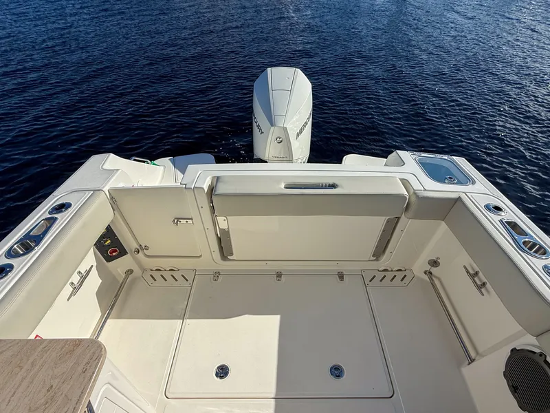 Slide: The Image of The image shows the stern of a Boston Whaler 240 Vantage boat on the water. - 13