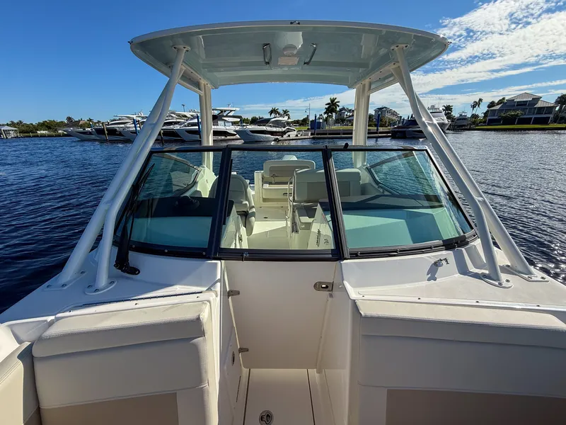 Slide: The Image of The image shows a 2027 Boston Whaler 240 Vantage boat on calm water. - 17
