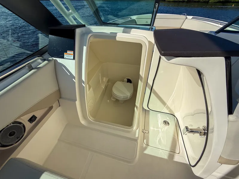 Slide: The Image of The image shows the interior of a 2027 Boston Whaler 240 Vantage with a toilet. - 20