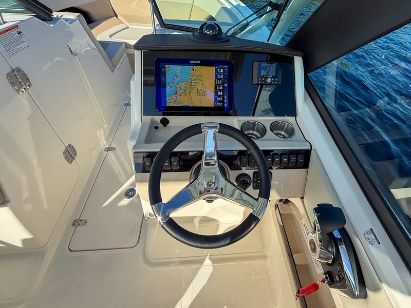 Slide: The Image of The cockpit of the 2027 Boston Whaler 240 Vantage features a modern steering wheel and navigation system. - 12