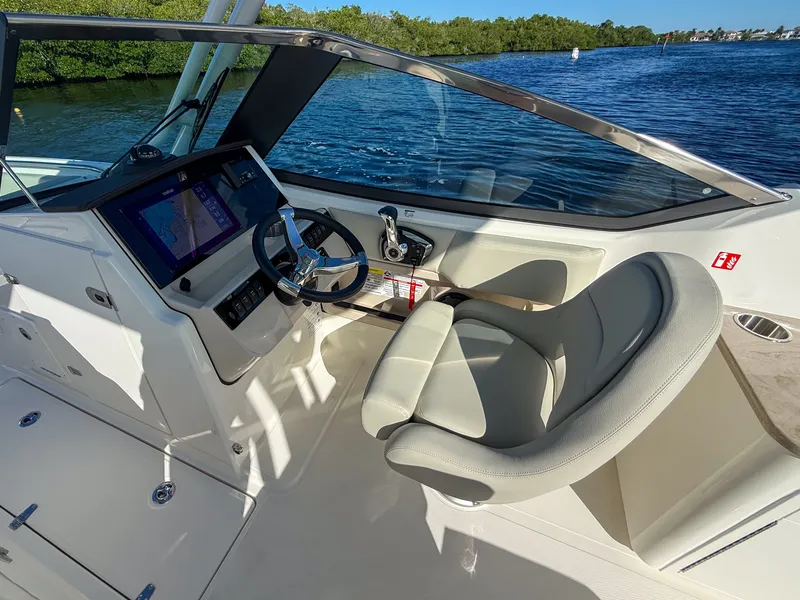 Slide: The Image of The image shows the cockpit of a 2027 Boston Whaler 240 Vantage with a modern helm. - 11