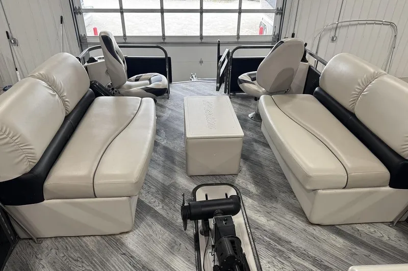 Slide: The Image of 2016 Manitou 24 Aurora LE Angler interior with plush seating and modern design. - 11