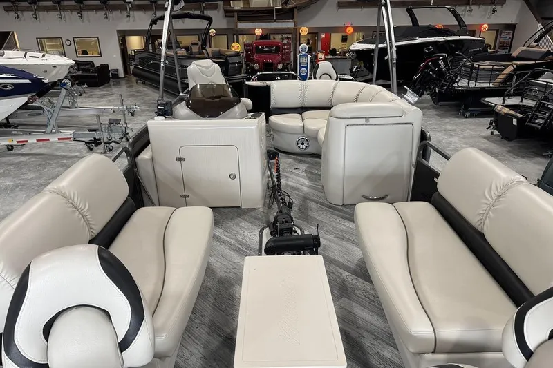 Slide: The Image of 2016 Manitou 24 Aurora LE Angler pontoon boat interior with beige seating. - 13