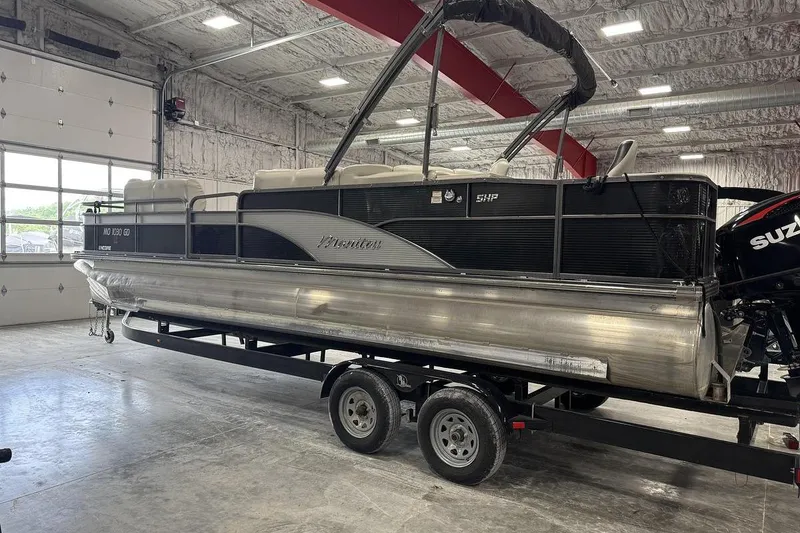 Slide: The Image of 2016 Manitou 24 Aurora LE Angler pontoon boat in a garage on a trailer. - 3