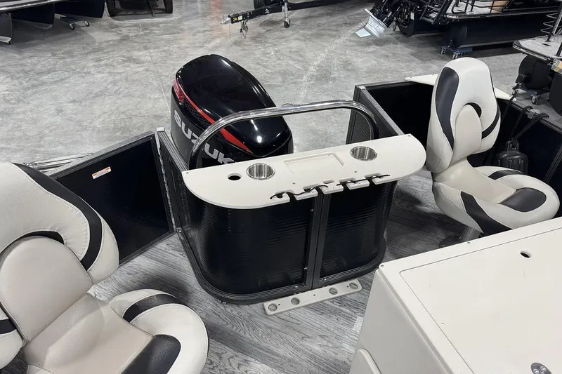 Slide: The Image of 2016 Manitou 24 Aurora LE Angler boat interior with Suzuki engine and seating. - 7