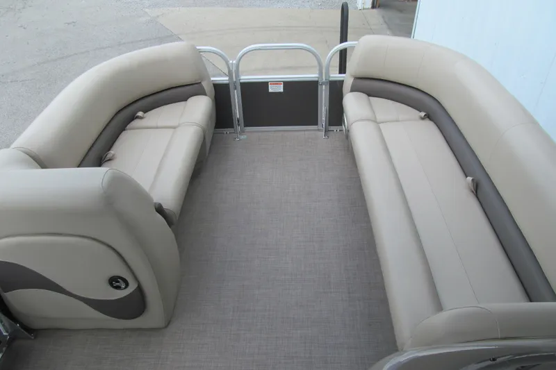 Slide: The Image of 2023 Sun Tracker Party Barge 18 DLX interior with beige seating and spacious layout. - 6