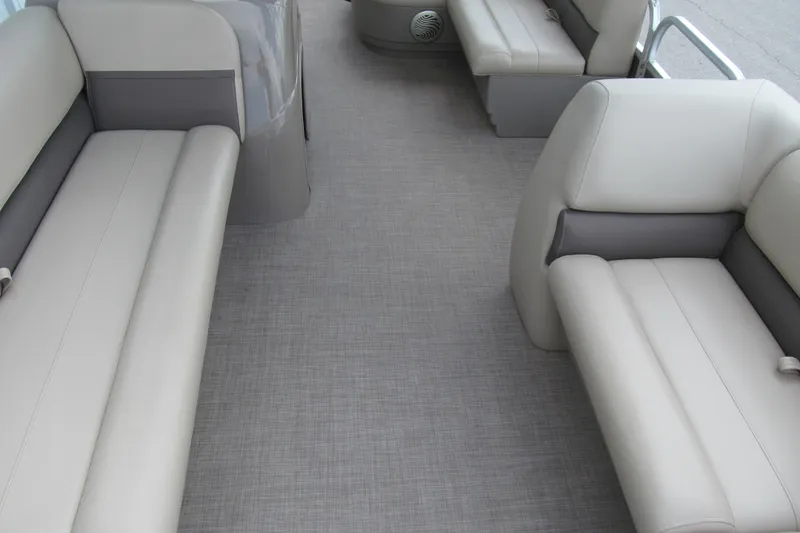 Slide: The Image of 2023 Sun Tracker Party Barge 18 DLX interior with gray seating and flooring. - 7