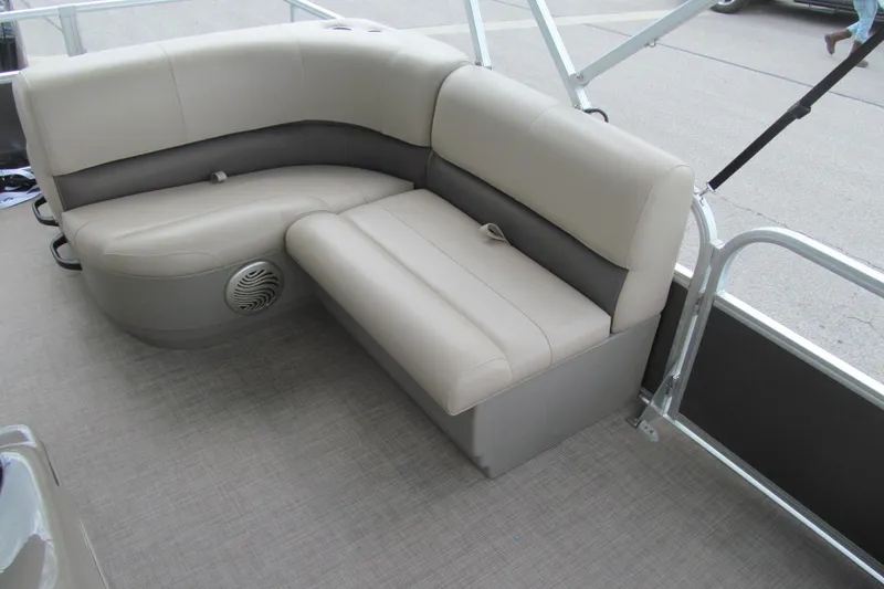 Slide: The Image of 2023 Sun Tracker Party Barge 18 DLX interior seating with beige upholstery and speaker. - 8