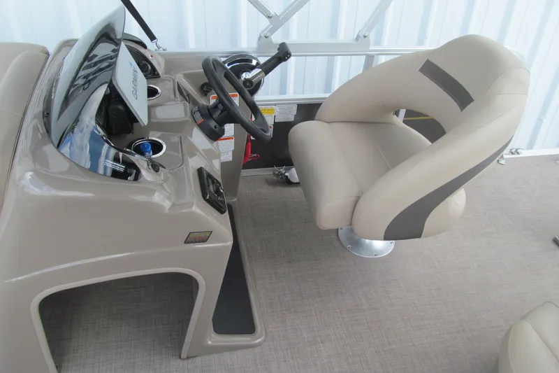 Slide: The Image of 2023 Sun Tracker Party Barge 18 DLX helm with beige captain's chair and steering console. - 9