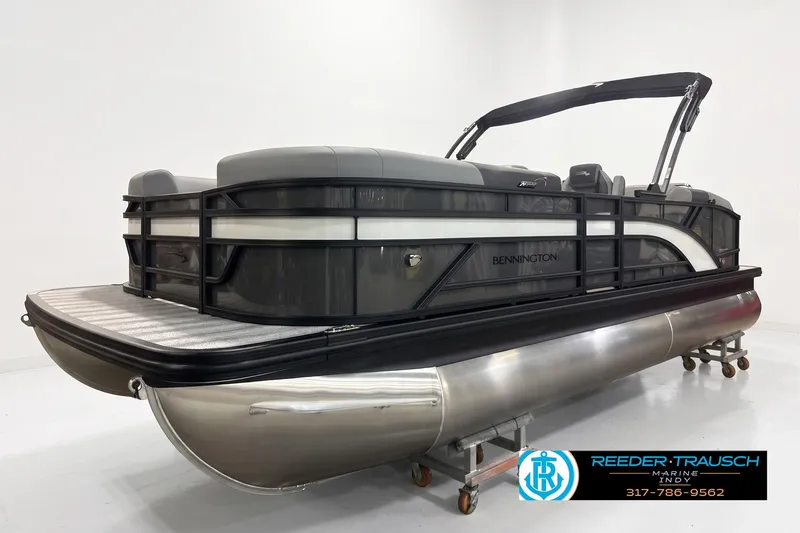 Slide: The Image of 2026 Bennington 22 SSB pontoon boat with sleek design in showroom setting. - 2