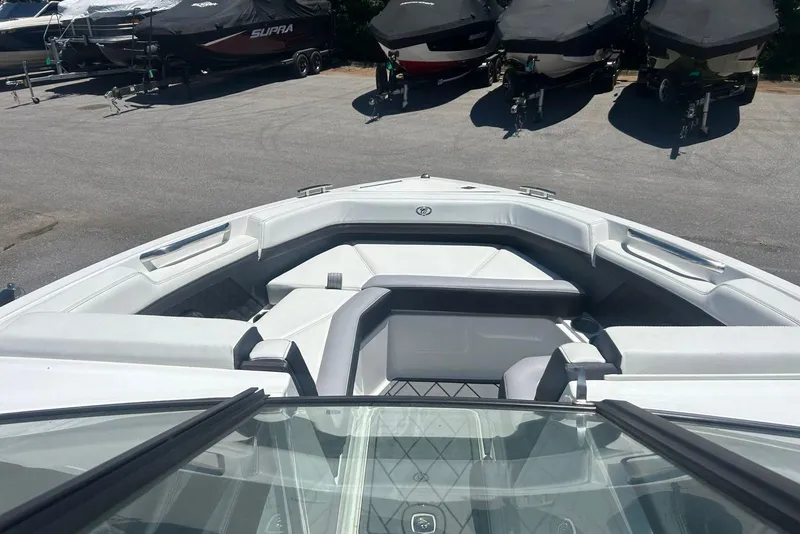 Slide: The Image of 2021 Cobalt R6 boat interior with sleek seating, parked among covered boats. - 4