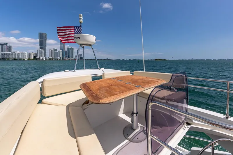 Slide: The Image of Flybridge view of 2011 Beneteau Gran Turismo 49 Fly yacht with city skyline backdrop. - 16