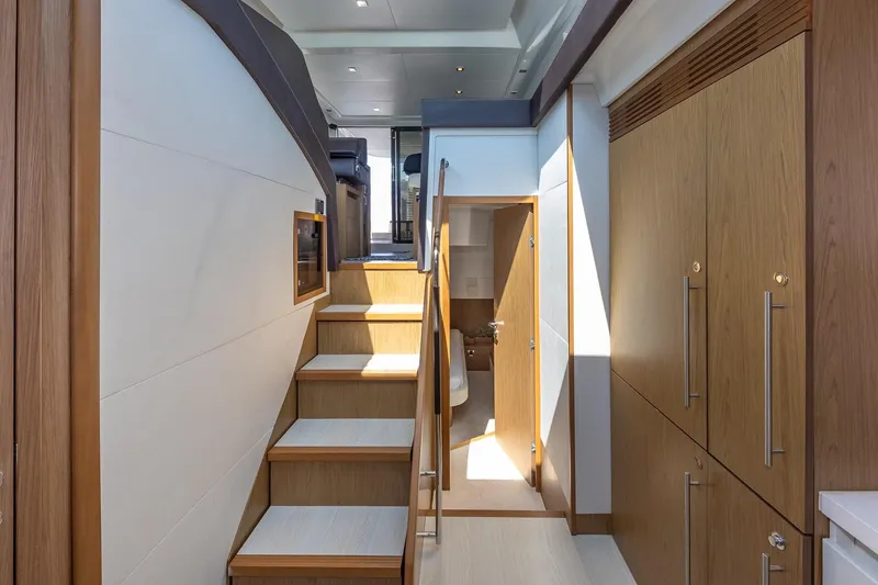 Slide: The Image of Interior of 2011 Beneteau Gran Turismo 49 Fly yacht, featuring wooden stairs and cabinetry. - 27