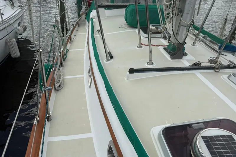 Slide: The Image of 1989 Cabo Rico 34 sailboat deck with green trim and rigging details. - 10