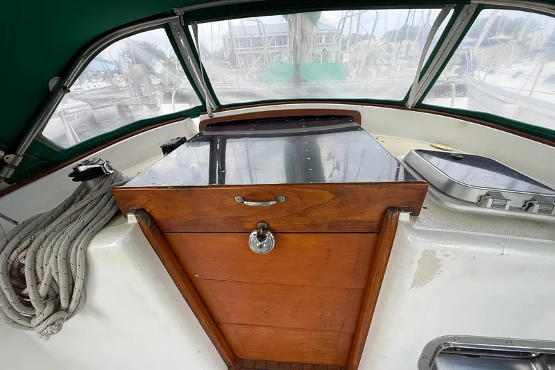 Slide: The Image of Cockpit of 1989 Cabo Rico 34 sailboat with wooden hatch and green canopy. - 15