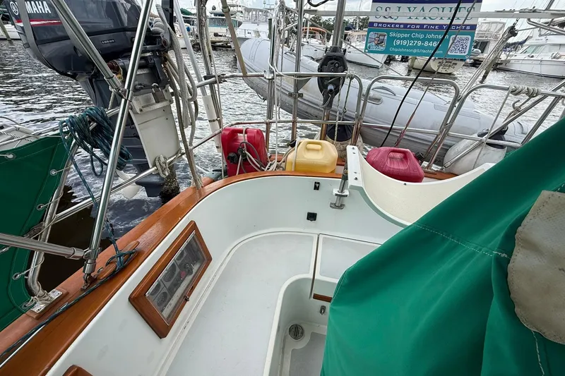 Slide: The Image of Cockpit view of 1989 Cabo Rico 34 sailboat with Yamaha outboard motor and fuel containers. - 16