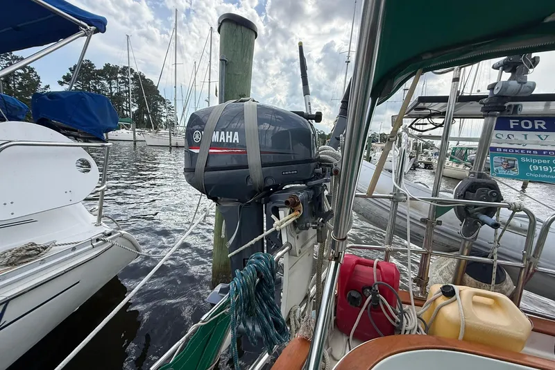 Slide: The Image of 1989 Cabo Rico 34 sailboat with Yamaha outboard motor docked at marina. - 17