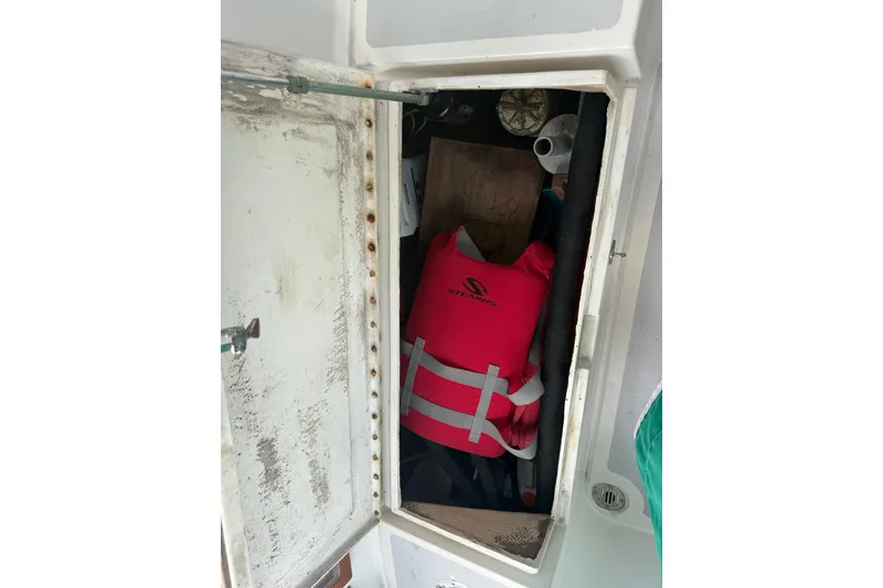 Slide: The Image of Open storage compartment on 1989 Cabo Rico 34 sailboat with pink life jacket inside. - 21