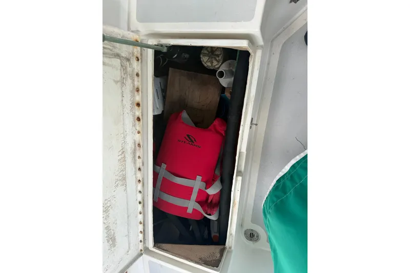 Slide: The Image of Storage compartment on a 1989 Cabo Rico 34 sailboat with a life jacket inside. - 22