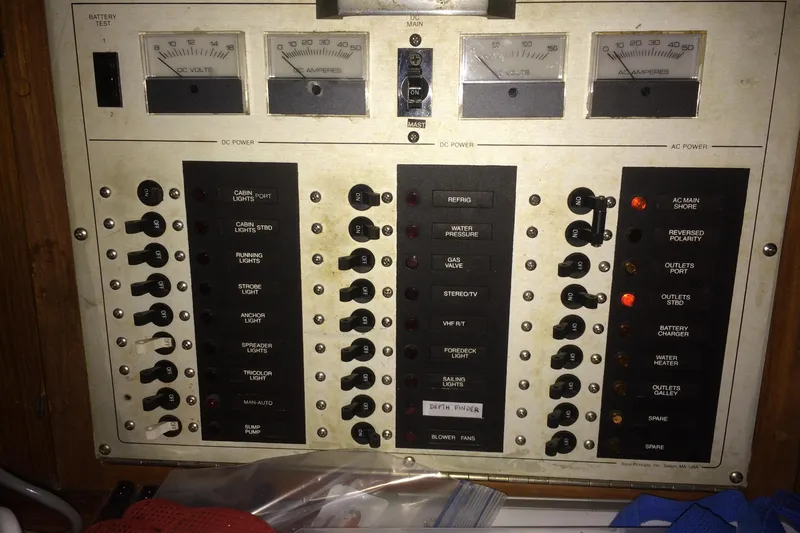 Slide: The Image of Electrical control panel on a 1989 Cabo Rico 34 sailboat, featuring various switches and gauges. - 30