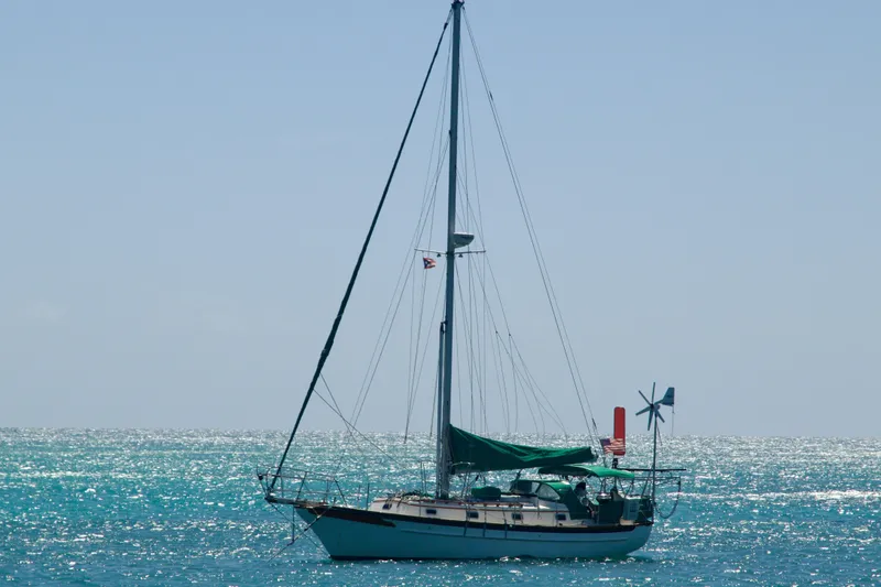 Slide: The Image of Sailboat Cabo Rico 34, 1989 model, anchored on sparkling turquoise sea. - 33