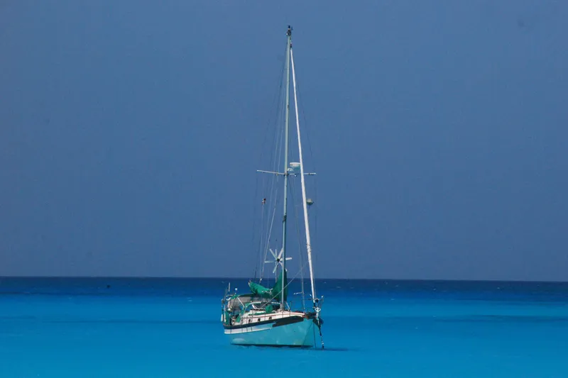 Slide: The Image of Sailboat Cabo Rico 34 (1989) on calm blue sea under clear sky. - 34