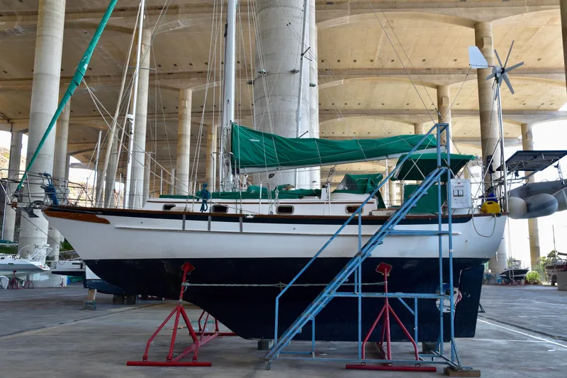 Slide: The Image of 1989 Cabo Rico 34 sailboat on stands in a covered marina. - 5