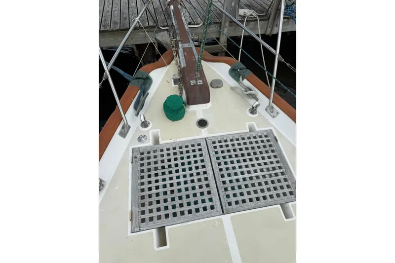 Slide: The Image of Cabo Rico 34 sailboat deck, 1989 model, featuring wooden accents and metal fittings. - 9