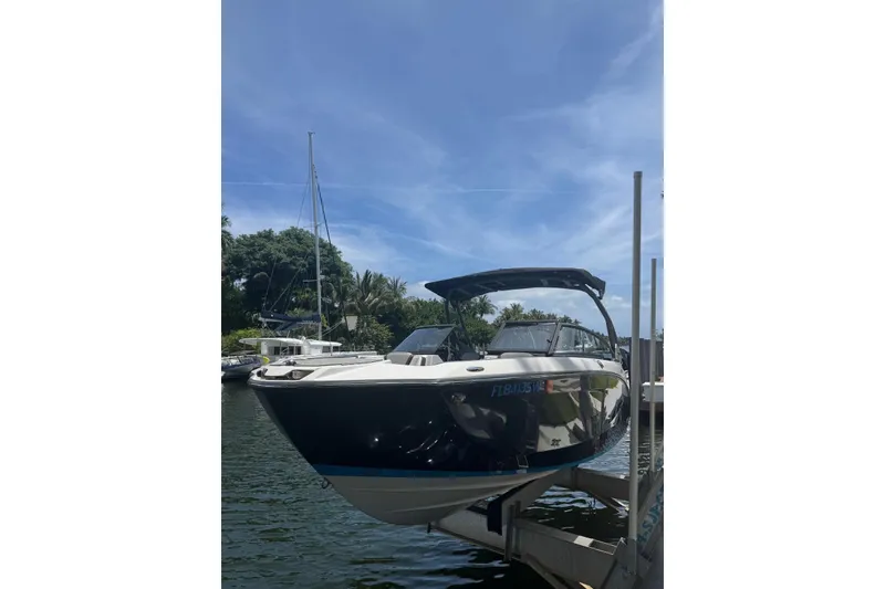 The Image of 2021 Yamaha Boats 252SD docked on a sunny day, showcasing sleek design. - 0