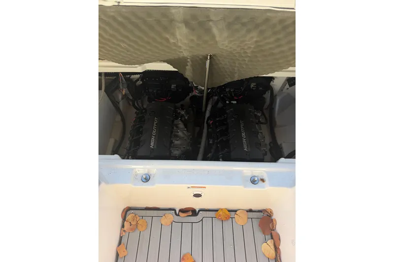 Slide: The Image of 2021 Yamaha Boats 252SD engine compartment with high output engines and fallen leaves. - 5