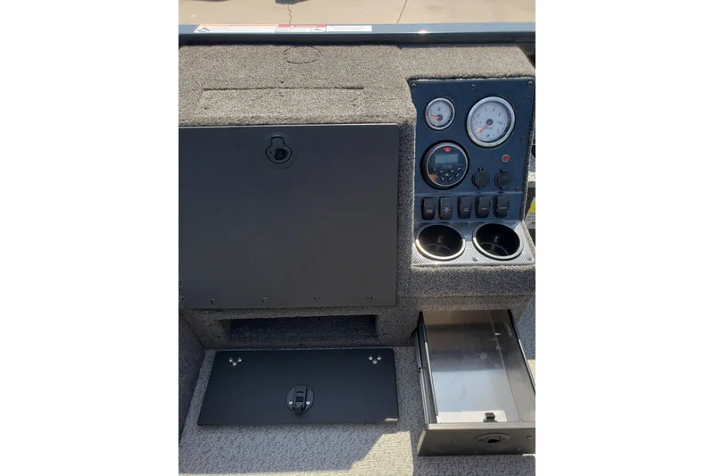 Slide: The Image of 2024 Crestliner 1650 Pro Tiller dashboard with gauges, storage compartments, and cup holders. - 11