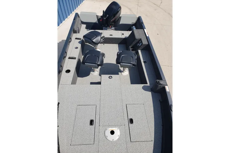 Slide: The Image of 2024 Crestliner 1650 Pro Tiller boat interior with seating and storage compartments. - 5