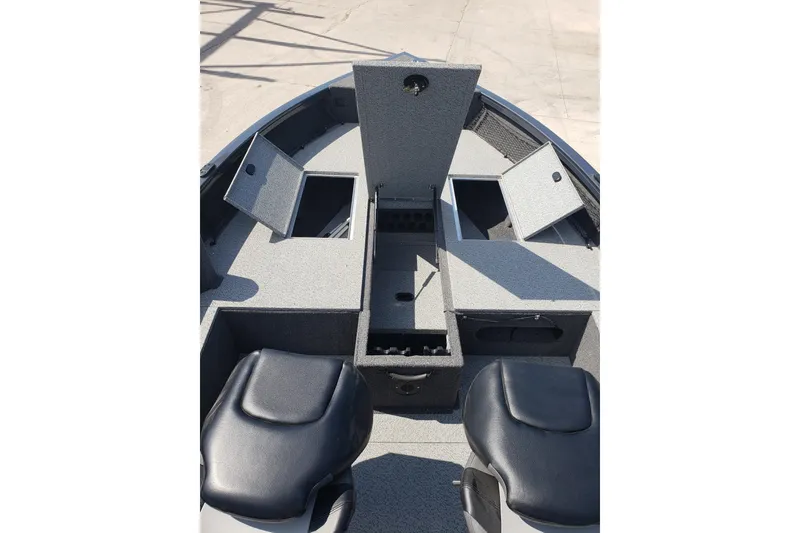 Slide: The Image of 2024 Crestliner 1650 Pro Tiller boat interior with storage compartments and seating. - 6
