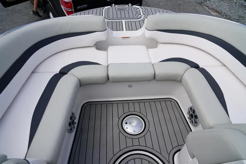 Slide: The Image of 2019 Starcraft Star Step 221 E I/O boat interior with cushioned seating and sleek flooring. - 11