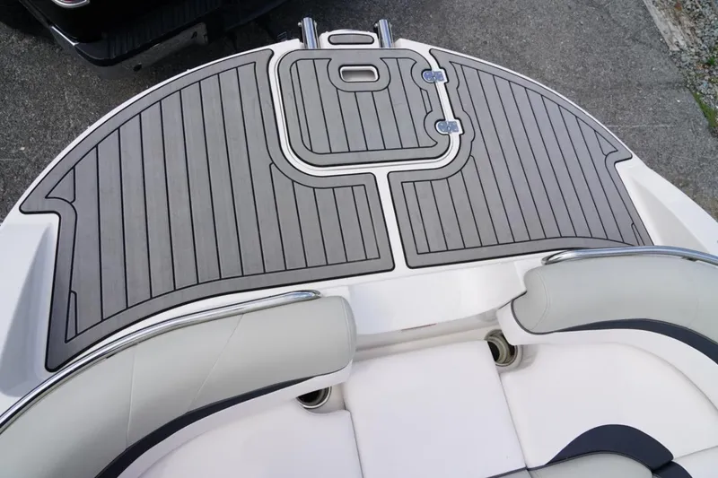 Slide: The Image of 2019 Starcraft Star Step 221 E I/O boat deck with sleek gray and white design. - 12