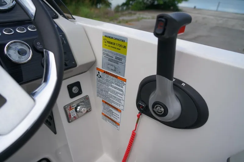 Slide: The Image of Control panel of a 2019 Starcraft Star Step 221 E I/O boat, featuring steering wheel and throttle. - 18