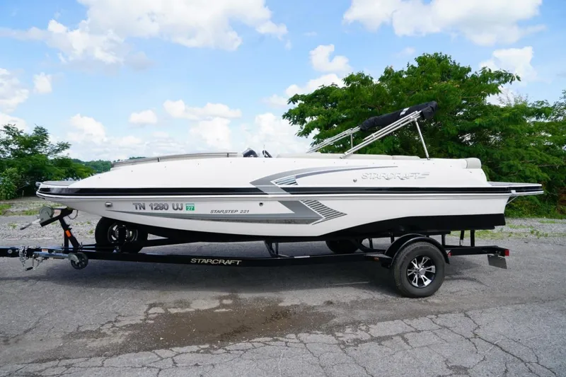 Slide: The Image of 2019 Starcraft Star Step 221 E I/O boat on trailer, parked outdoors. - 2