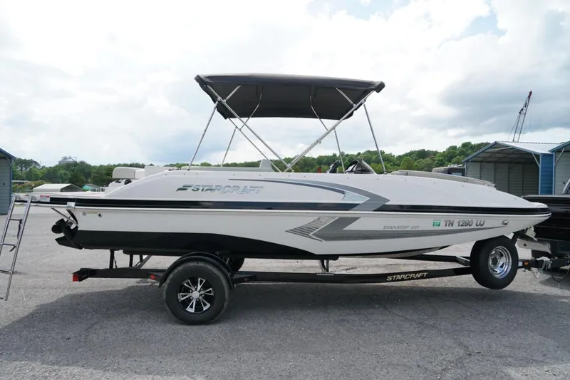 Slide: The Image of 2019 Starcraft Star Step 221 E I/O boat on trailer, parked outdoors. - 20