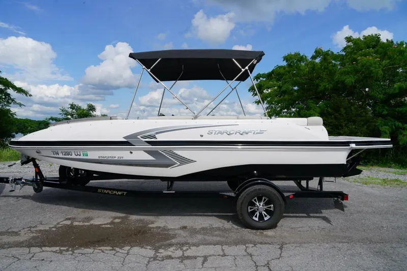 Slide: The Image of 2019 Starcraft Star Step 221 E I/O boat on trailer, parked outdoors. - 21