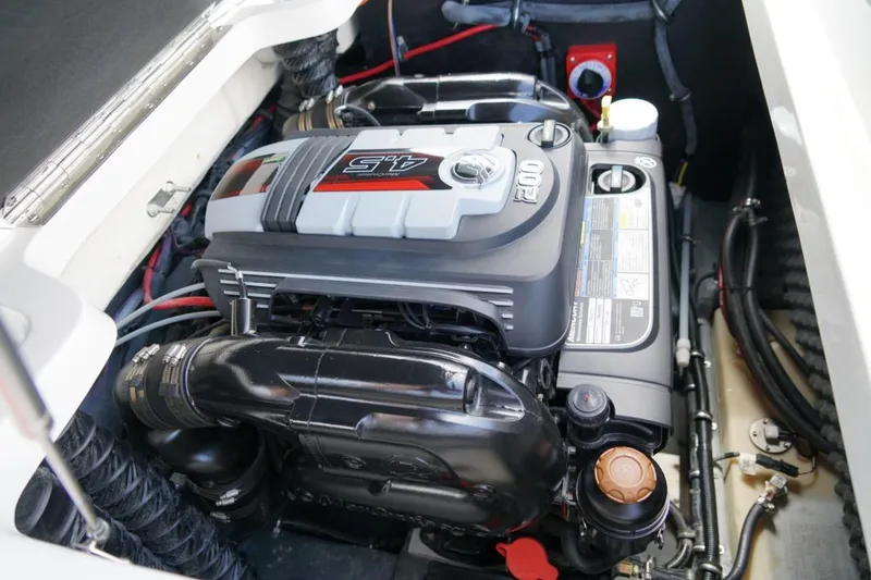 Slide: The Image of 2019 Starcraft Star Step 221 E I/O boat engine compartment, showcasing a powerful motor. - 24