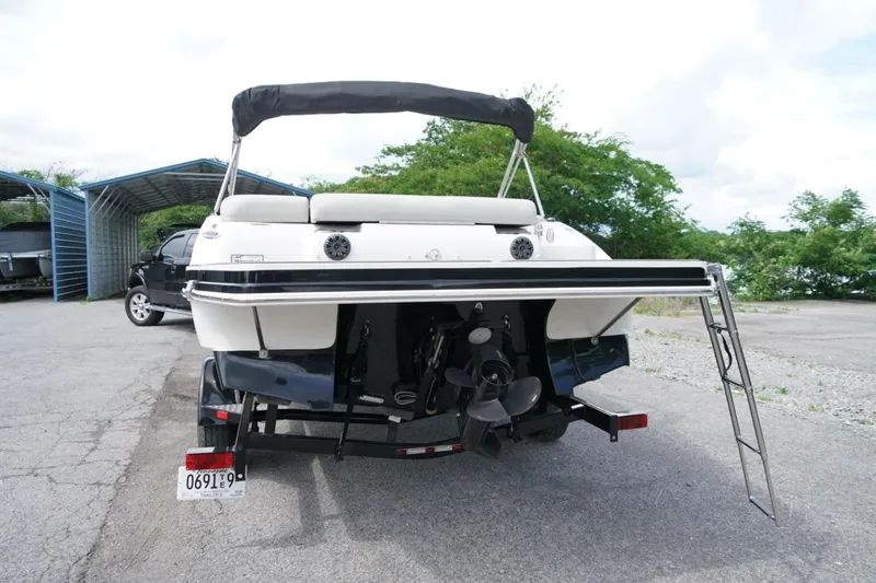 Slide: The Image of 2019 Starcraft Star Step 221 E I/O boat on trailer, rear view with ladder. - 3