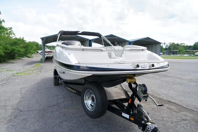 Slide: The Image of 2019 Starcraft Star Step 221 E I/O boat on trailer, parked outdoors. - 4