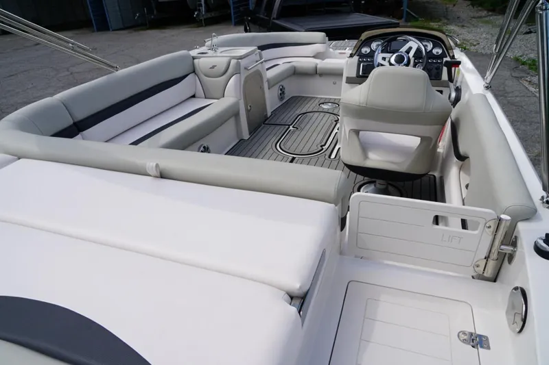 Slide: The Image of 2019 Starcraft Star Step 221 E I/O boat interior with seating and steering console. - 7