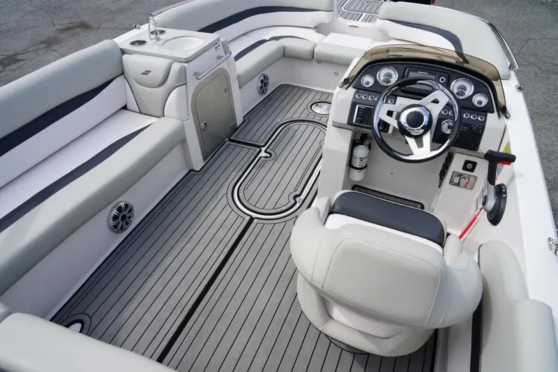 Slide: The Image of 2019 Starcraft Star Step 221 E I/O boat interior with sleek seating and modern dashboard. - 9