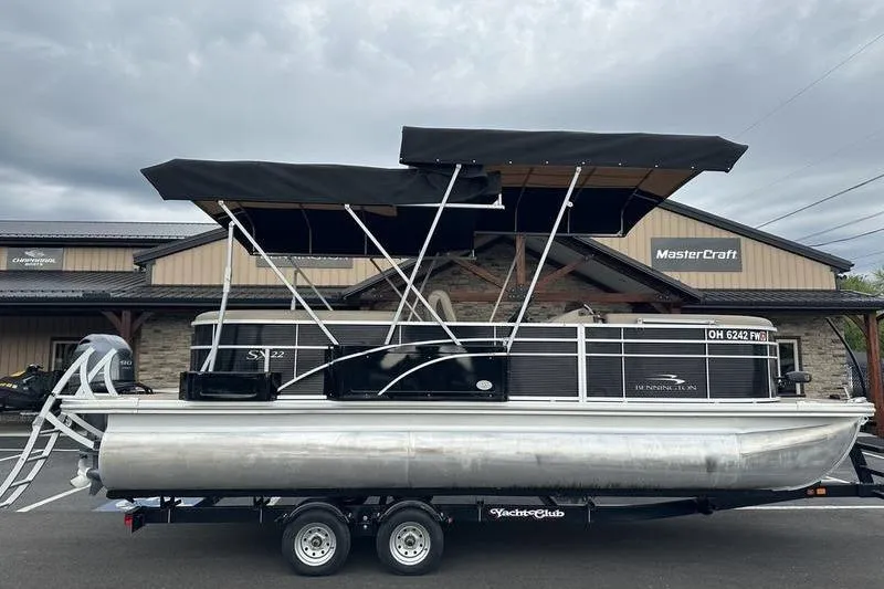 Slide: The Image of 2022 Bennington 22 SSRX pontoon boat on trailer, parked outside dealership. - 13